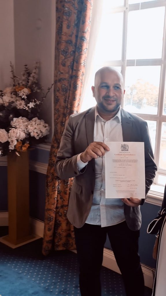 Hussam collecting his Nationalisation certificate